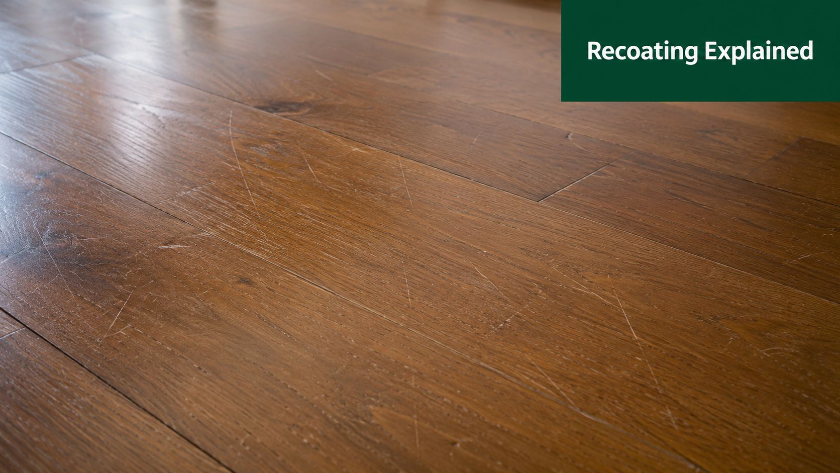 A close-up shot of worn dark wood flooring showing visible surface scratches and signs of wear.